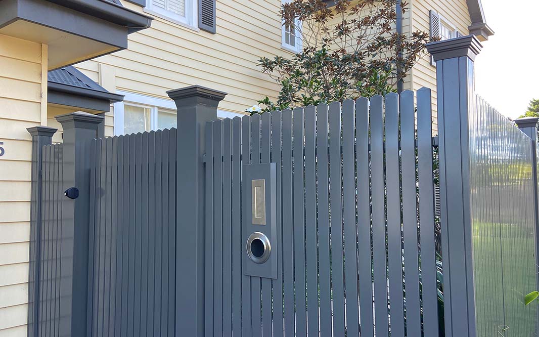 A modern aluminium fence with a gate and door