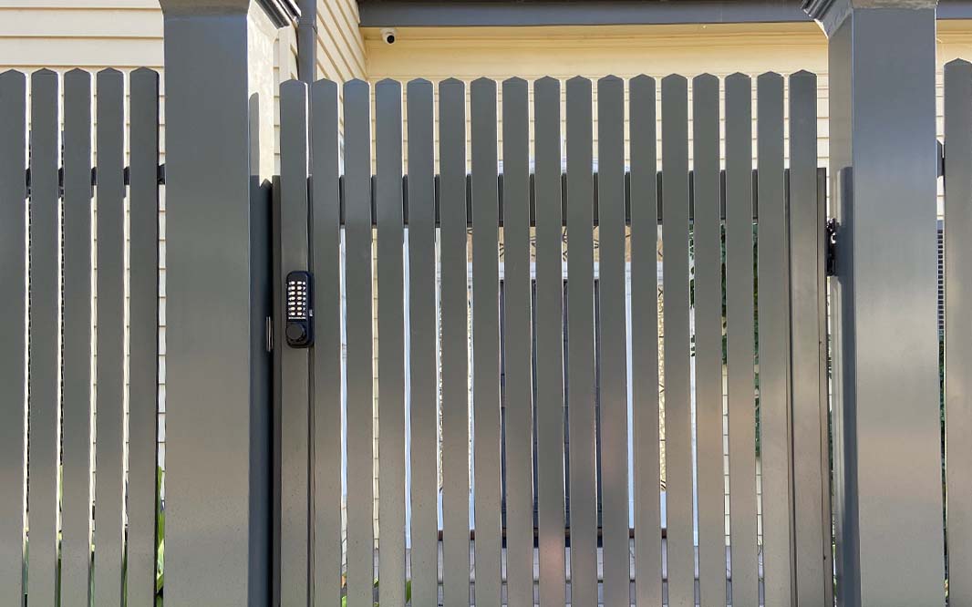 Aluminium fence with a gate and door, providing security and access to the enclosed area