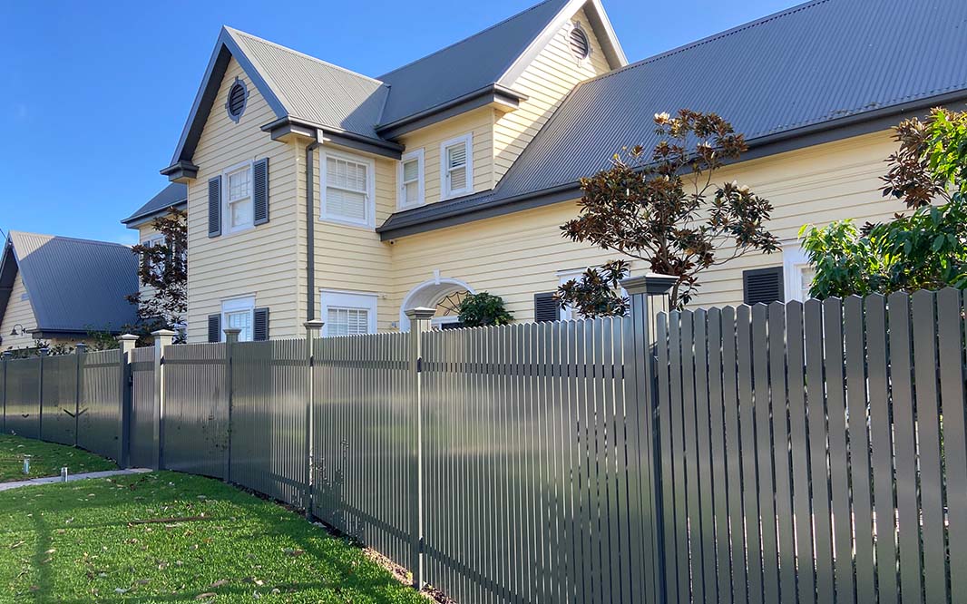 A house with Aluminium Pool Fencing installed in front of it